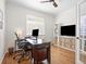 Bright office space features a large window, built-in shelving, and ample space for productivity at 15915 E Summit Fox Ave, Parker, CO 80134