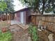 Back of detached garage, and lawnmower. Backyard is fenced at 1078 Elmira St, Aurora, CO 80010