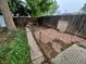 Fenced backyard with mature tree and brick patio area at 1078 Elmira St, Aurora, CO 80010