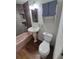 Updated bathroom boasts grey tiled shower, pink tub, sink and toilet at 1078 Elmira St, Aurora, CO 80010
