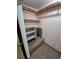 Walk-in closet boasts built-in shelving, carpeted floor, and ample storage space at 1078 Elmira St, Aurora, CO 80010