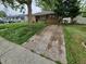 Quaint single-story home with long cracked driveway surrounded by overgrown grass and mature trees at 1078 Elmira St, Aurora, CO 80010