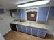 Kitchen with blue cabinets, a white counter, and a black stove at 1078 Elmira St, Aurora, CO 80010