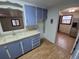 View of kitchen with blue cabinets, white sink, and stainless steel refrigerator at 1078 Elmira St, Aurora, CO 80010
