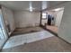 An empty room with carpet and tile flooring, featuring neutral walls and a stainless steel refrigerator at 1078 Elmira St, Aurora, CO 80010