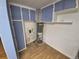 Utility room features blue storage cabinets and a water heater at 1078 Elmira St, Aurora, CO 80010