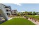 Large backyard featuring lush artificial turf, fence and steps to the upper level at 2141 Fountain Cir, Erie, CO 80516