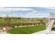 Backyard featuring manicured lawn, bordered flower beds, and a view of the surrounding nature at 2141 Fountain Cir, Erie, CO 80516