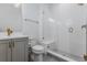 Modern bathroom featuring tiled walk-in shower with glass door, gray vanity, and gold fixtures at 2141 Fountain Cir, Erie, CO 80516