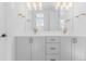 Bathroom showcasing double vanity, sleek gray cabinets, quartz counters, and elegant gold fixtures at 2141 Fountain Cir, Erie, CO 80516