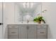 Bright bathroom featuring a large mirror, stylish lighting, and a vanity with ample storage at 2141 Fountain Cir, Erie, CO 80516
