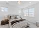 Sunlit bedroom with neutral tones, plush bedding, and large windows providing ample natural light at 2141 Fountain Cir, Erie, CO 80516