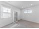 Bright bedroom featuring neutral carpet, a built-in bookshelf, and natural light from multiple windows at 2141 Fountain Cir, Erie, CO 80516
