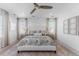 Inviting bedroom featuring a large window, ceiling fan and neutral tones at 2141 Fountain Cir, Erie, CO 80516