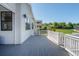 Exterior shot of a spacious gray deck featuring white railings and a view of surrounding neighborhood at 2141 Fountain Cir, Erie, CO 80516