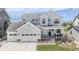 Beautifully designed two-story home featuring a charming front porch, three-car garage, and modern architectural details at 2141 Fountain Cir, Erie, CO 80516