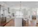 Bright, open-concept kitchen featuring a large island, stainless steel appliances, and modern lighting fixtures at 2141 Fountain Cir, Erie, CO 80516