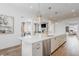 Open-concept kitchen with a large island, stainless steel appliances, and modern pendant lighting at 2141 Fountain Cir, Erie, CO 80516
