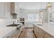 Spacious kitchen with stainless steel appliances, a gas cooktop, white cabinetry and an island with bar seating at 2141 Fountain Cir, Erie, CO 80516
