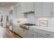 Kitchen featuring stainless steel appliances, white cabinetry, and a tiled backsplash, perfect for culinary enthusiasts at 2141 Fountain Cir, Erie, CO 80516