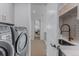 Convenient laundry room with modern appliances, sink, and ample cabinet space, offering functionality at 2141 Fountain Cir, Erie, CO 80516