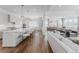 Bright, open-concept living space showcasing a gourmet kitchen, dining area, and inviting living room with hardwood floors at 2141 Fountain Cir, Erie, CO 80516