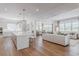 Bright, open-concept living space showcasing a gourmet kitchen, dining area, and inviting living room with hardwood floors at 2141 Fountain Cir, Erie, CO 80516
