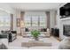Elegant living room featuring a modern fireplace, large windows, and sophisticated decor with stylish furniture at 2141 Fountain Cir, Erie, CO 80516