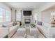 Bright living room with modern decor, a fireplace, and large windows that flood the space with natural light at 2141 Fountain Cir, Erie, CO 80516