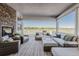 Inviting outdoor living area with comfortable seating, fireplace, and expansive views of the surrounding landscape at 2141 Fountain Cir, Erie, CO 80516