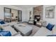 Relaxing outdoor living space featuring a fireplace, comfortable seating, and seamless indoor-outdoor flow for entertaining at 2141 Fountain Cir, Erie, CO 80516