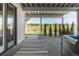 Covered patio area with views of a green yard and neighboring houses at 2141 Fountain Cir, Erie, CO 80516