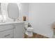 Stylish powder room featuring a modern vanity, gold fixtures, and a decorative oval mirror at 2141 Fountain Cir, Erie, CO 80516