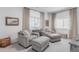 Comfortable sitting area featuring plush armchairs, ottomans, and natural light from large windows at 2141 Fountain Cir, Erie, CO 80516