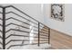 Modern staircase with sleek horizontal railings and light wood floors leading to upper level at 2141 Fountain Cir, Erie, CO 80516