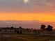 Beautiful evening view of the Rocky Mountains and the Colorado skyline near a paved road and fields at 2141 Fountain Cir, Erie, CO 80516