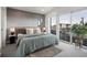 Modern bedroom features a textured accent wall, stylish decor, and a light-filled view from sliding glass doors at 1262 N Stuart St # 2, Denver, CO 80204