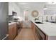 Modern kitchen with stainless steel appliances, hardwood floors, and a large island with barstool seating at 1262 N Stuart St # 2, Denver, CO 80204