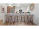Modern kitchen with an island, bar stools, stainless steel appliances, and white countertops, perfect for entertaining at 1262 N Stuart St # 2, Denver, CO 80204