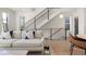 Bright living room with modern staircase, hardwood floors, and a comfortable sofa at 1262 N Stuart St # 2, Denver, CO 80204