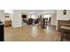 Open basement area with laminate wood flooring leading to a carpeted living space and a bathroom at 3325 W 111Th Loop # C, Westminster, CO 80031