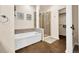 Bright bathroom offering a sleek shower and a luxurious soaking tub at 3325 W 111Th Loop # C, Westminster, CO 80031