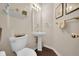 Stylish powder room with a pedestal sink and decorative shelf at 3325 W 111Th Loop # C, Westminster, CO 80031