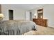 Bedroom with a large bed, dresser, and a decorative mirror adding elegance and charm to the space at 3325 W 111Th Loop # C, Westminster, CO 80031