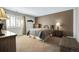Cozy bedroom with a comfortable bed, neutral carpeting, and a window with wooden blinds at 3325 W 111Th Loop # C, Westminster, CO 80031