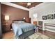 Bright bedroom featuring a plush bed, wood floors, and warm, natural lighting at 3325 W 111Th Loop # C, Westminster, CO 80031