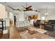 Spacious open-concept living room with hardwood floors and a kitchen bar at 3325 W 111Th Loop # C, Westminster, CO 80031
