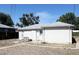 Backyard showing the exterior of the home, patio, and minimal landscaping at 933 Skeel St, Brighton, CO 80601