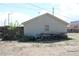 A view of the backyard and detached garage featuring a messy yard at 933 Skeel St, Brighton, CO 80601