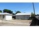 Exterior view of detached garage in the backyard, yard is covered in dry grass at 933 Skeel St, Brighton, CO 80601